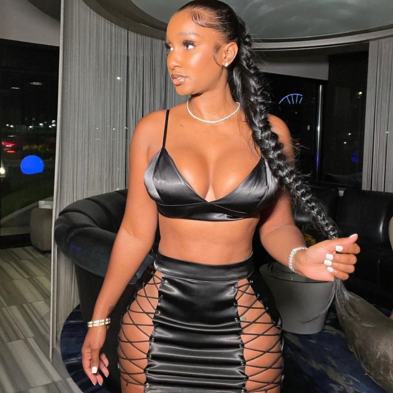 Bernice Burgos Spotted in Chicago Wearing Black Satin Lace-up Skirt Set by Fashion Nova