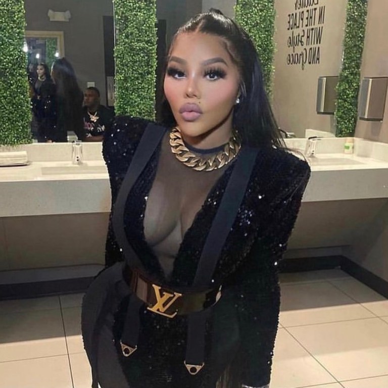 Lil Kim Performs at Mississippi’s Trapcella Wearing Custom Michael Costello Black Sequin and Mesh Jumpsuit, Louis Vuitton Logo Belt and Kandee Black Vinyl Boots