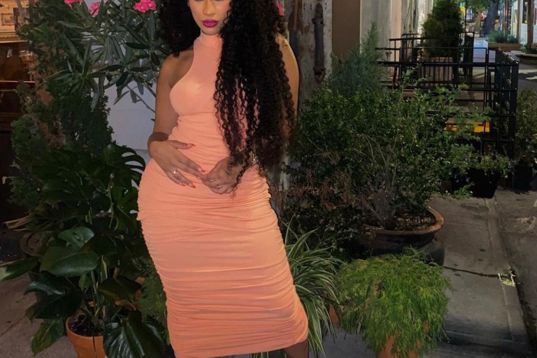 Cyn Santana Poses in Fashion Nova Orange Mock Neck Ruched Dress
