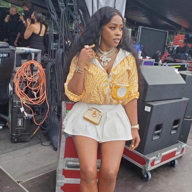 Remy Ma Performs at ‘We Love NYC’ Concert Wearing Fendi Yellow and White Logo Jacket, Purse, and Socks Paired With Ms. Bling Pleated White Mini Skirt and Chanel PVC Boots