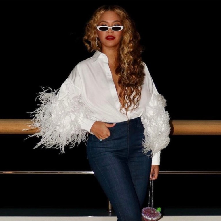 Beyoncé Spotted Yachting in Capri With Jay-Z Wearing Valentino White Feather Shirt, Flare Leg Jeans, PHILÓ White Sunglasses, and Judith Leiber Martini Clutch