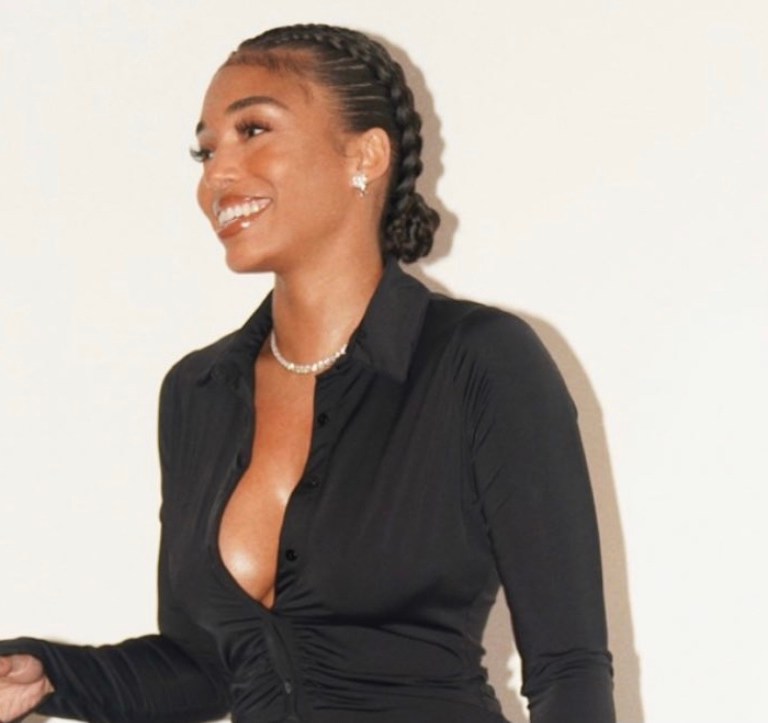 Lori Harvey Flashes Her Smile Wearing With Jean Black Ruched Button Shirt Dress Paired With Hermès Burgundy Croc Handbag and Versace Black Lace-Up Sandals