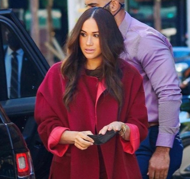 Meghan Markle Visits School and Donates to Local Restaurant in New York City Wearing Loro Piana Red Cashmere Cape and Wide Leg Pants