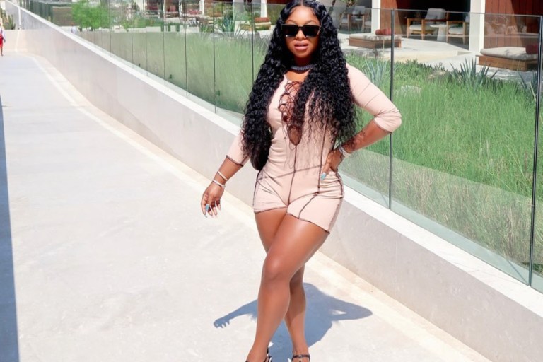 Reginae Carter Soaks Up the Sun in Lace-Up Long Sleeve Romper by Fashion Nova