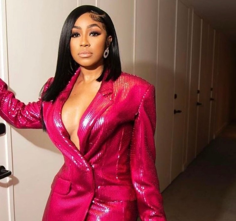 Yung Miami Attends Marcell Von Berlin’s Spring 2022 Show Wearing the Brand’s Fall 2021 Pink Sequin Suit and Silver Bag