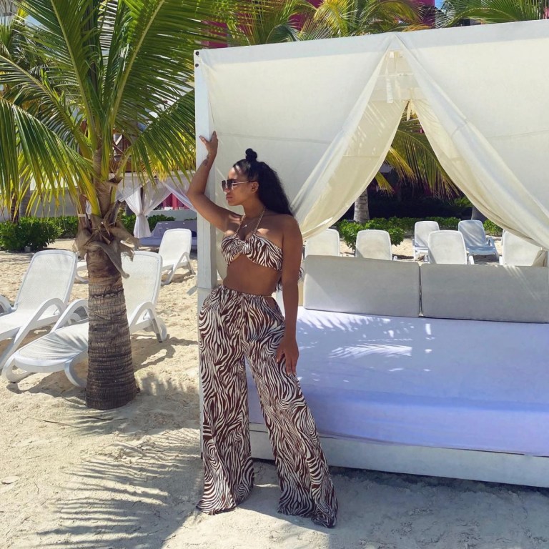 Cyn Santana Enjoys Vacation in Cancun Wearing Fashion Nova Animal Print Chain Halter Top and Wide Leg Pant Set