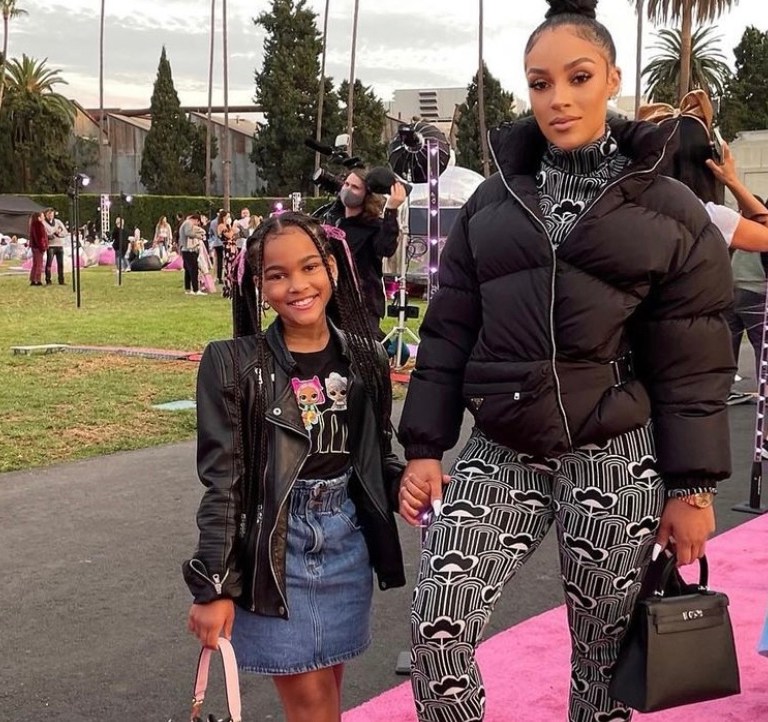 Joie Chavis Attends the LOL Surprise! Movie Premiere With Daughter Shai Wearing Prada Black and White Floral Print Jacquard Jumpsuit and Black Puffer Jacket + K. Michelle Spotted in Prada Floral Pieces