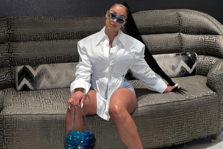 Most Requested: Joie Chavis Continues Her Birthday Celebration With Recent Outing Wearing Mugler White Structured Open Back Top and Denim Shorts Paired With Bottega Veneta Wire Sandals and Crystal Chanel Handbag