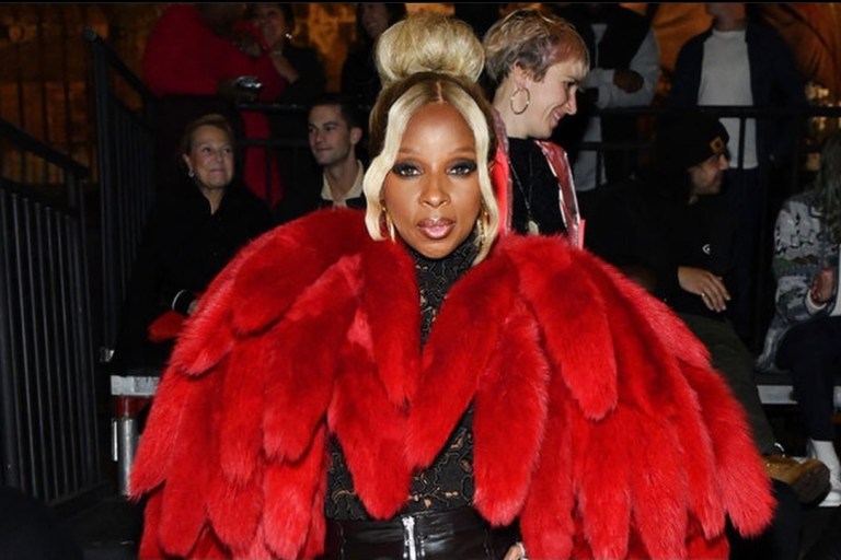 Mary J. Blige Dons Bottega Veneta Red Shearling Padded Tails Coat, Black Zipper-Detail Leather Pants, and Black Floral Embroidery Top to the Brand’s Salon 03 Show in Detroit
