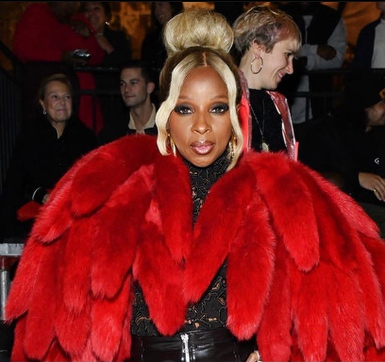 Mary J. Blige Dons Bottega Veneta Red Shearling Padded Tails Coat, Black Zipper-Detail Leather Pants, and Black Floral Embroidery Top to the Brand’s Salon 03 Show in Detroit