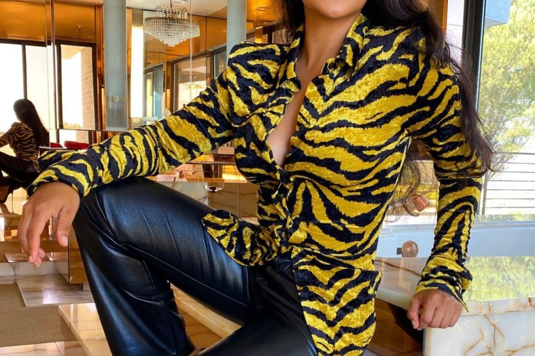 Wardrobe Inquiry: Shantel Jackson Wears The Attico Yellow and Black Zebra Print Velvet Shirt With AGOLDE Black Vegan Leather Pants and Prada Crystal Embellished Bag