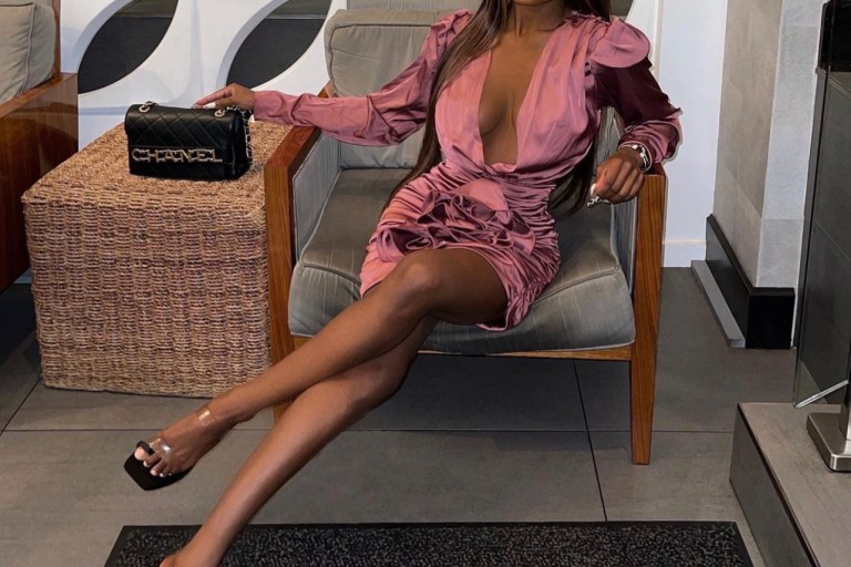 Yahné Coleman Sits Pretty While Rocking Her Fashion Nova Mauve Ruffle Satin Dress