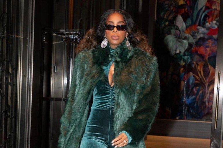 Kelly Rowland Performs at the 2021 Macy’s Thanksgiving Day Parade Wearing Custom Marcell Von Berlin Green Look Including Velvet Cutout Jumpsuit, Thigh-High Boots, and Long Fur Coat