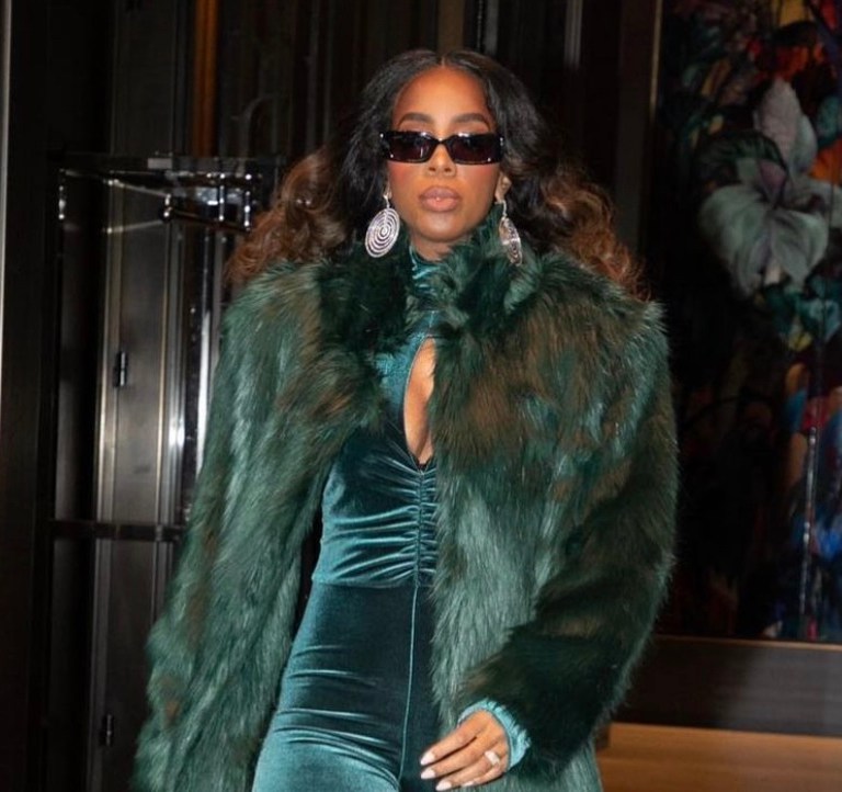 Kelly Rowland Performs at the 2021 Macy’s Thanksgiving Day Parade Wearing Custom Marcell Von Berlin Green Look Including Velvet Cutout Jumpsuit, Thigh-High Boots, and Long Fur Coat