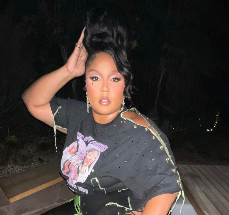 Lizzo Attends Harry Styles’ Concert in LA Wearing Stinson Haus Look Including Custom Fan Behavior Distressed T-Shirt and Lace-Up Pants