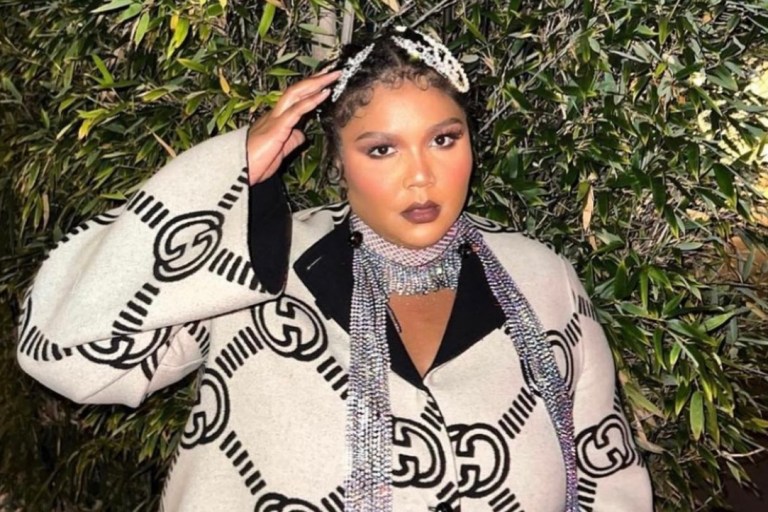 Lizzo Attends the Gucci Love Parade Wearing the Brand’s Reversible Logo Maxi Coat, Black Mini Tote Bag, and Monogram Slingback Pumps