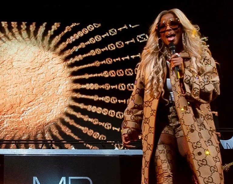 Mary J. Blige Performs at Barclays Center Wearing Gucci Fall 2021 Monogram Crystal Embellished Coat, Shorts, and Balenciaga Collaboration Thigh-High Boots