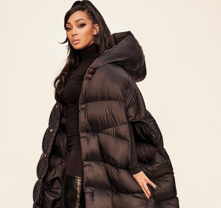 Monica Stuns in All Black Look Featuring Rick Owens Fall 2021 Floor-Length Hooded Puffer Vest, Wolford Turtleneck Top and Pants, and Balenciaga Leather Over-the-Knee Boots