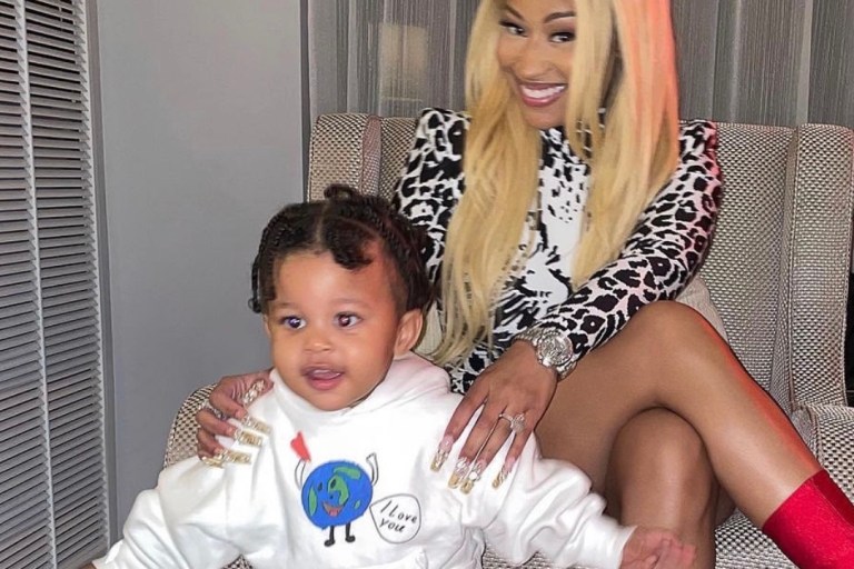 Nicki Minaj Shares Photos of Son Papa Bear Wearing Balenciaga White Earth Print Hoodie, Orange Logo Shorts, and Black Sandals