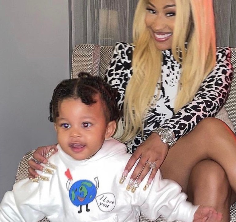 Nicki Minaj Shares Photos of Son Papa Bear Wearing Balenciaga White Earth Print Hoodie, Orange Logo Shorts, and Black Sandals
