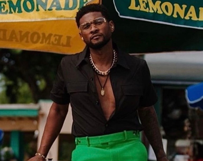 Usher Spotted Roller Skating in Miami Wearing Full Bottega Veneta Look Including Green Wool Suit Jacket, Pants, and Black Short Sleeve Shirt