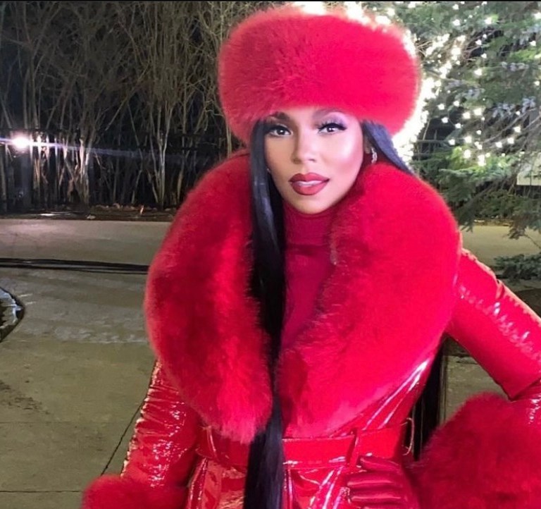 Ashanti Delivers Ultimate Holiday Glam for Performance at Foxwoods Resort Casino: Red Style Moment Featuring Custom Daniel’s Leather Faux Faur and Leather Coat and Hat Paired With Jennifer Le Black Croc Embossed Boots