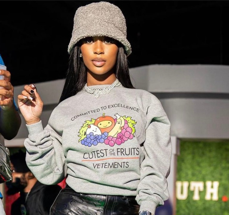 Dess Dior Spotted at Truth Nightclub Wearing Vetements Grey Fruits Graphic Sweatshirt, Marine Serre Black Moon Print Leather Trousers, Grey Fuzzy Bucket and Air Jordan 11 ‘Cool Grey’ Sneakers
