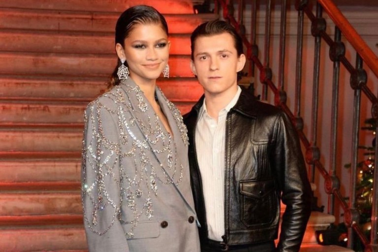 Zendaya and Tom Holland Are ‘Couple Goals’ at the London Premiere of ’Spider-Man: No Way Home”: Zendaya Wears Alexander McQueen Spring 2022 Crystal-Embroidered Grey Blazer Jacket and Thigh-High Boots With Tom Holland in Celine