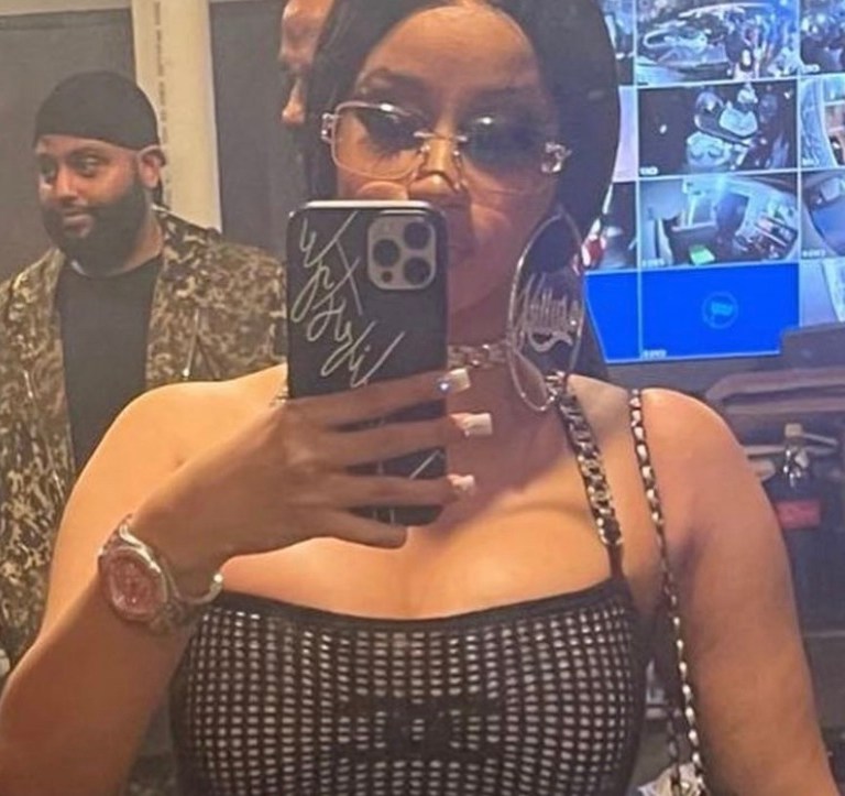 Cardi B Celebrates New Year’s Eve Wearing Chanel Resort 2022 Black Fishnet Logo Mini Dress