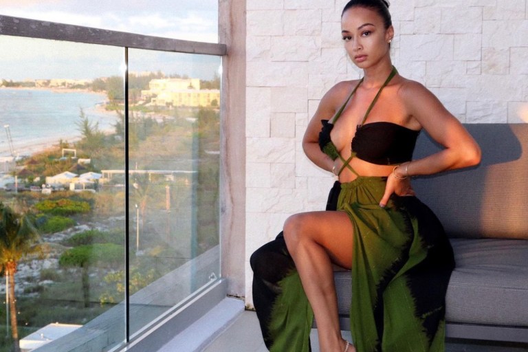 Draya Michele Delivers Vacay Style Moment Wearing Fashion Nova Olive Green Cutout Halter Maxi Dress