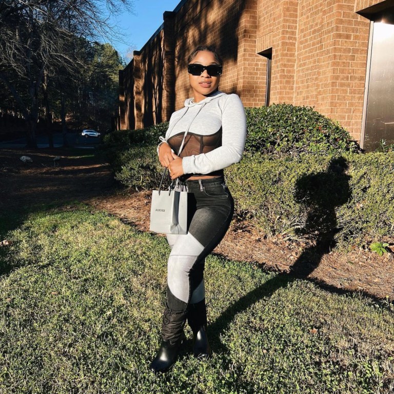 Reginae Carter Steps Out in Grey and Black Look Featuring Fashion Nova Patchwork Skinny Jeans
