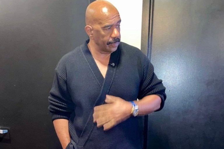 Steve Harvey Appears on ‘Jimmy Kimmel Live’ Wearing Dunhill Black Wrap Cardigan Paired With Gucci Black Monogram Leather Pants and Bottega Veneta Boots