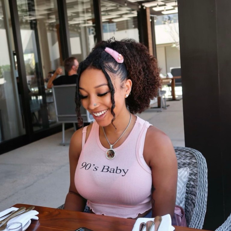 Zonnique Pullins Dines with Her Friends Wearing Pink ’90’s Baby’ Tank Top from Fashion Nova