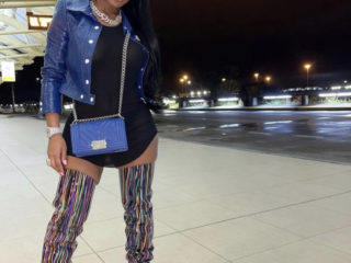 Jayda Cheaves Struck a Pose while Wearing a $1,200 Dark Blue Courreges Jacket with $149 Rick Owens Black Tank Top and Multicolor Striped Vetements Thigh High Boots