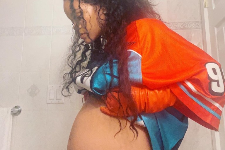 Rihanna Debuts Her Baby Bump Wearing Vintage No Limit 1999 Jersey and $1,400 Prada Orange Leather Gloves