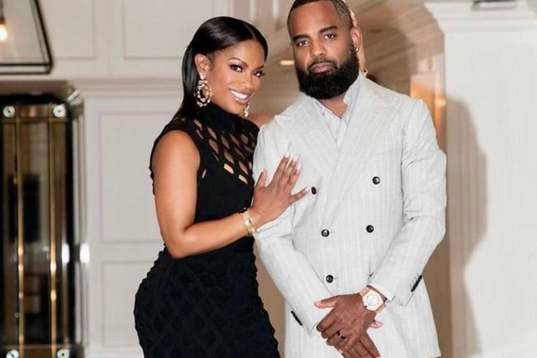 Kandi Burruss Attends Oscars Festivities with Todd Tucker Wearing Black Herve Leger Net Fringed Gown