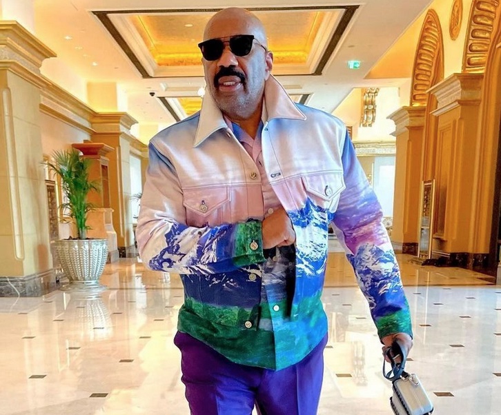Steve Harvey Steps in Abu Dhabi Styled in a Louis Vuitton x Virgil Abloh Purple and Green Landscape Jacket and Matching Shirt