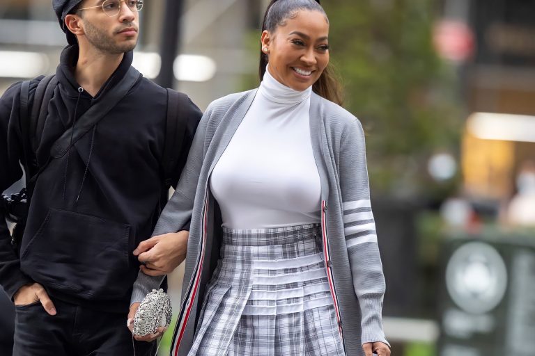 Lala Anthony Hits Thom Browne Show Wearing Thom Browne T Bar Cardigan and Pleated Skirt
