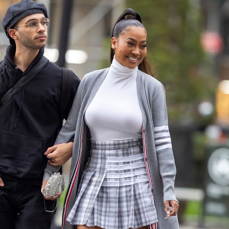 Lala Anthony Hits Thom Browne Show Wearing Thom Browne T Bar Cardigan and Pleated Skirt