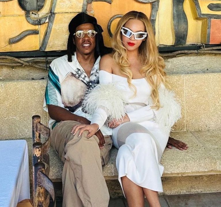 Fashion Bomb Couple:  Beyoncé Wore a White Feathered LaPointe Dress and Brandon Blackwood handbag with Jay-Z in Jil Sander while Exploring Nice, France