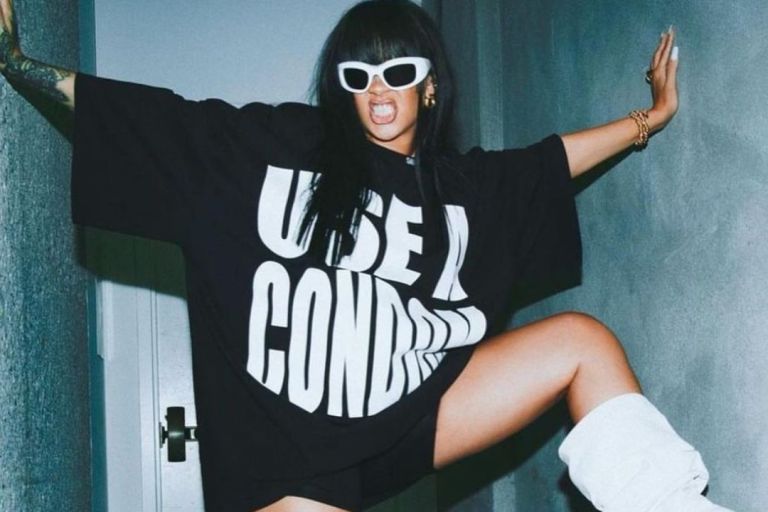 Rihanna Posed for the Gram in a Black Savage X Fenty  “Wear A Condom” Shirt and White Amina Muaddi Boots