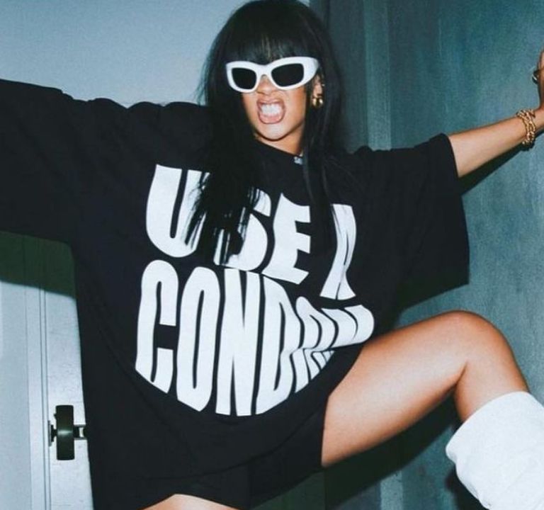 Rihanna Posed for the Gram in a Black Savage X Fenty  “Wear A Condom” Shirt and White Amina Muaddi Boots