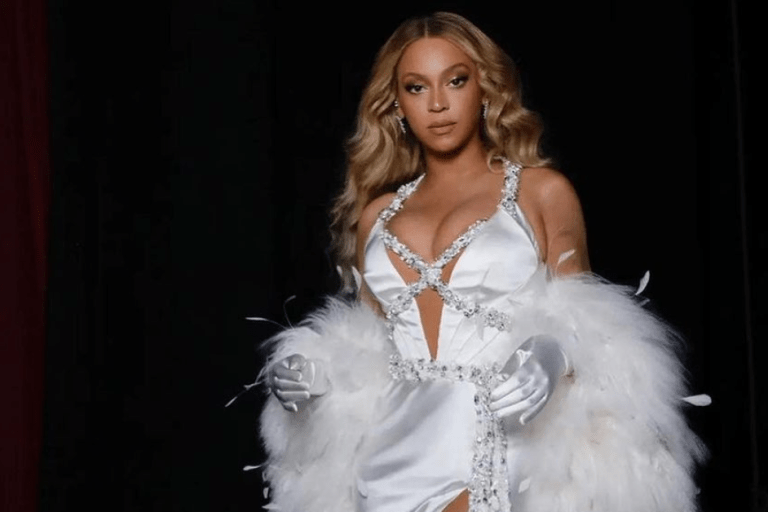 Beyoncé Served Old Hollywood Glamor in an All White Ralph Lauren Gown and Feather Boa