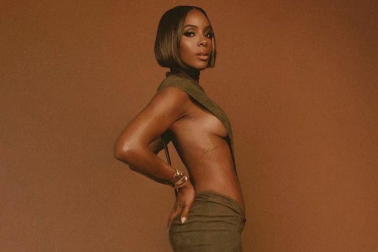 Kelly Rowland Stunned in a $1,000 Olive Green LaQuan Smith High-Cut Bodysuit with a Matching $1,300 Maxi Suede Skirt