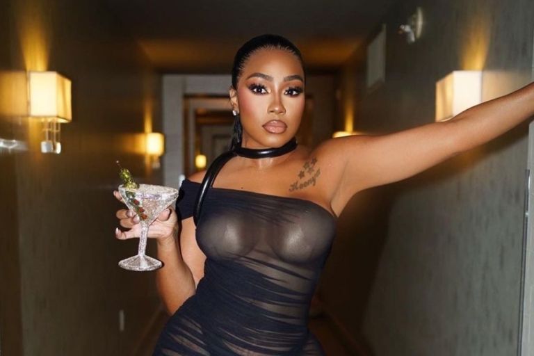 Yung Miami Looked Sizzling Haute in a Black $1,215 David Koma Asymmetrical Mini Dress with $875 Dolce & Gabbana Sheer Sandals at Dwayne Wade’s FWRD Party