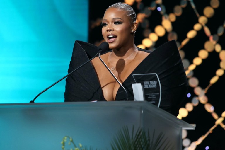 Claire’s Life: Receiving the Culture Creators 2024 Media Award, Presented by Angela Simmons, in a Black Bow Ken White Dress and Piferi Heels