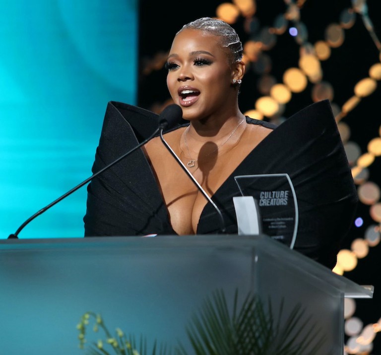 Claire’s Life: Receiving the Culture Creators 2024 Media Award, Presented by Angela Simmons, in a Black Bow Ken White Dress and Piferi Heels