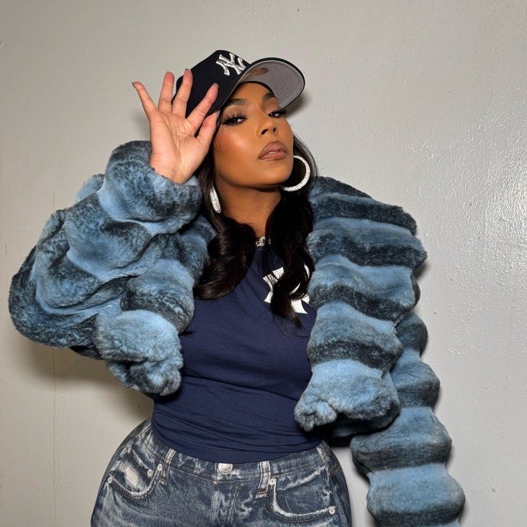 Ashanti Sang the National Anthem at Yankee Stadium Wearing a Daniel’s Leather Faux Fur Chinchilla Coat, Rag & Bone Denim Leggings, and Dolce & Gabbana Boots