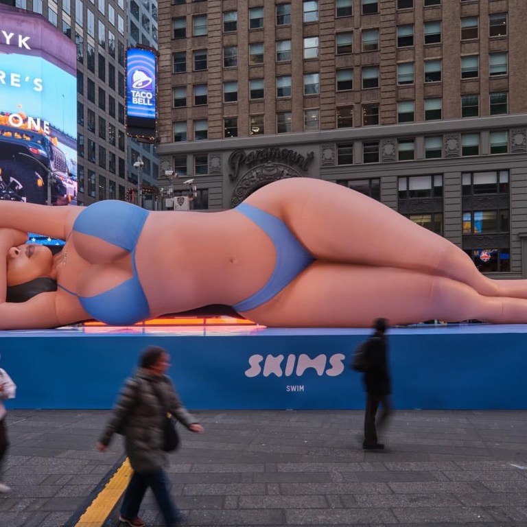 Kim Kardashian Promotes Skims Swim with a Blue Bikini Clad Blow Up Doll in Times Square