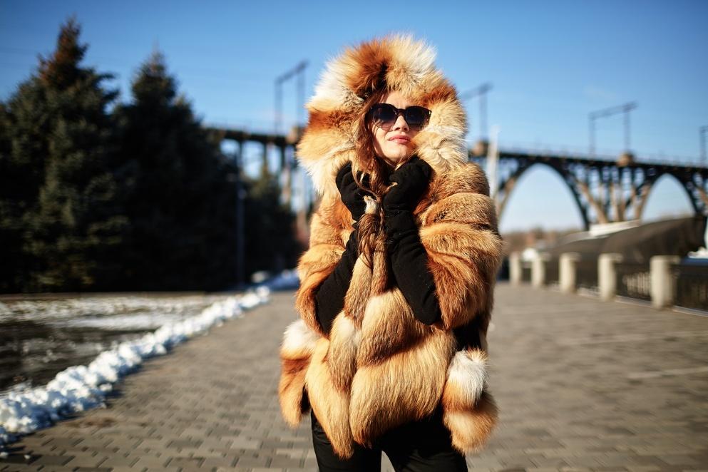 A person wearing sunglasses and a fur coat who might be looking for who buys furs near me.

